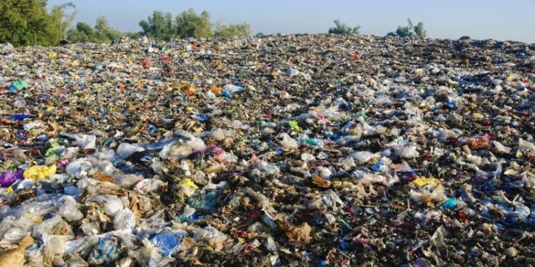 A sea of garbage starts to invade and destroy a beautiful countryside scenery