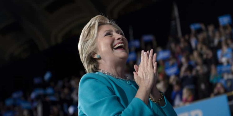 Democratic presidential nominee Hillary Clinton acknowledges supporters after speaking a rally at the Cleveland Public Auditorium November 6, 2016 in Cleveland, Ohio. Donald Trump barnstorms five states Sunday while Hillary Clinton implores her most fervent supporters to get to the polls, in a frenetic final 48-hour dash to the US presidential election. / AFP / Brendan Smialowski