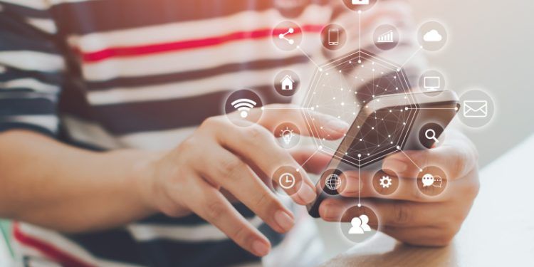 Man hand using smartphone with icon technology communication and internet of things (IOT). Innovative convenience smart life concept